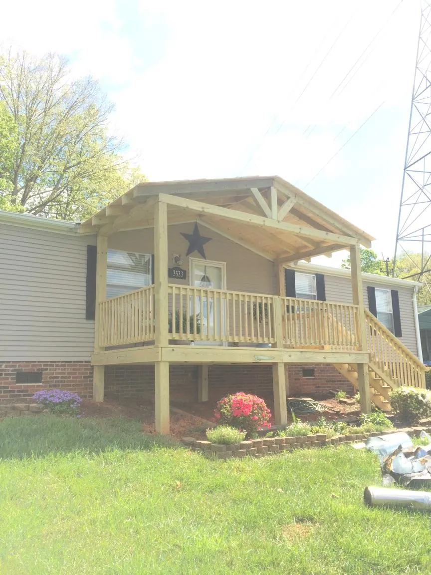 New gabled porch roof and deck railing added to a ranch home in Millville